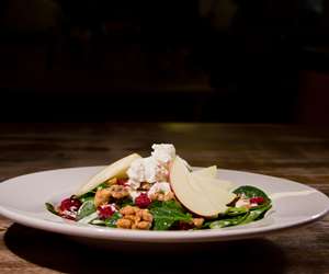 Baby spinach salad with local apples, dried cranberries, and Vermont goat cheese