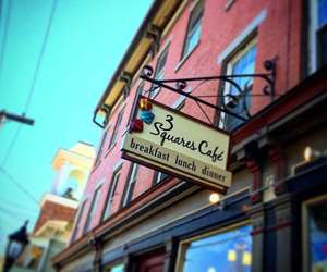 3 Squares Cafe sign with a bright blue sky