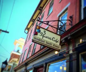 3 Squares Cafe sign with a bright blue sky